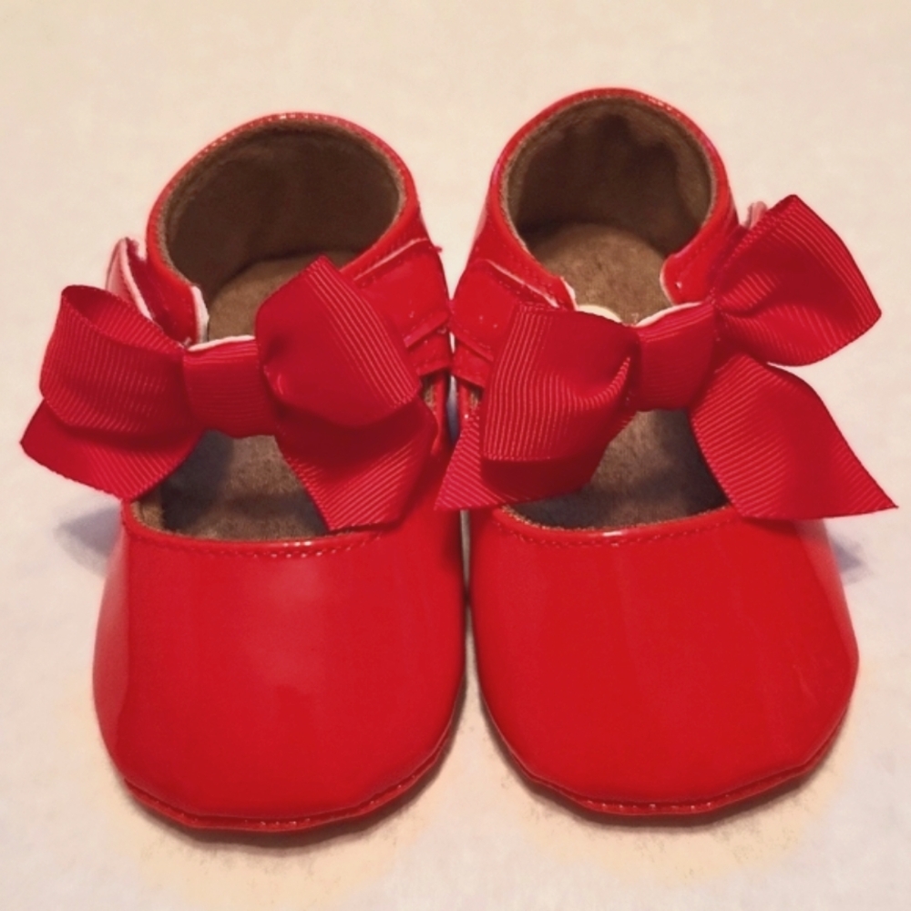 Shiny red Mary Jane style walking shoes with bow detail
